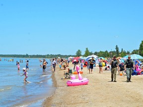 People relax at Sauble Beach on Saturday after the beach was reopened Friday. Most people appeared to be following public health regulations around physical distancing and limiting groups to under 10. Bylaw and OPP officers were also present. Rob Gowan/The Sun Times