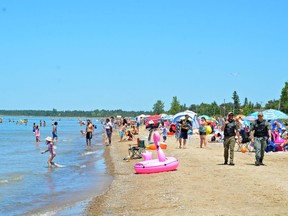 People relax at Sauble Beach on Saturday after the beach was reopened Friday. Most people appeared to be following public health regulations around physical distancing and limiting groups to under 10. Bylaw and OPP officers were also present.
Rob Gowan/The Sun Times