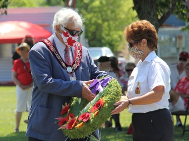 Pembroke Mayor Mike LeMay prepares to lay a wreath on behalf of the city, accompanied by Branch 72 executive member Laurette Halliday, during a ceremony of remembrance held at the city's waterfront on Canada Day. Anthony Dixon
