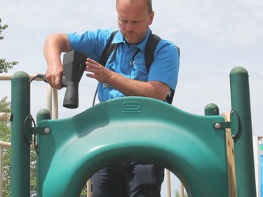 Stephan St-Andre electrostatically applies a eco-friendly, biodegradable but highly effective degreaser to the playstructure. Anthony Dixon