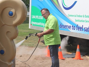 Dynamo president Richard Martin cleans the playground equipment at the waterfront using high heat steam pressure washer. Anthony Dixon