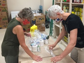 Pembroke food bank volunteers Janet Kelly and Myrna Kilborn package orders. Submitted photo