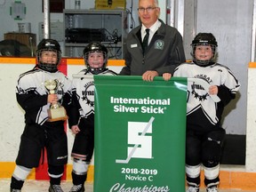 The 2020 Pembroke Regional Silver Stick tournament has been cancelled due to concerns surrounding COVID-19. Here tournament director Norbert Chaput presents the Novice C banner to members of the Muskrat Voyageurs in November 2018.