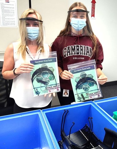 SRB Technologies (Canada) Inc. employees Sarah St-Pierre (left) and Lexxi Fitzpatrick have been busy packaging face shields. Here they show what the package looks like when it is shipped to customers.