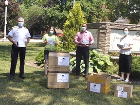 Various personal protective equipment (PPE), from suits to children-and-adult sized masks, were donated in West Perth July 2. On hand for the presentation at the municipal building were fire Chief Bill Hunter (left), Tracey Phillips, Perth Care for Kids; Jeff Renaud, adminstrator Ritz Lutheran Villa; Ms. Li Wenli, on behalf of herself and her husband Li ChangSen; Mayor Walter McKenzie and Ms. Chen Chunju. ANDY BADER/MITCHELL ADVOCATE