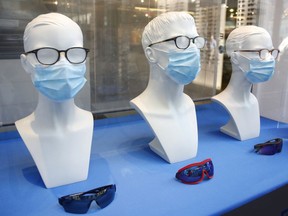 Busts decorated with protective masks are seen in a display window of an optician shop.
REUTERS/Arnd Wiegmann ORG XMIT: PPP-AW401