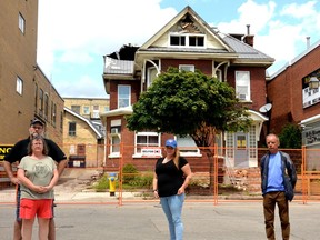 Annie Sebben, a sever at Molly Blooms, is flanked Wednesday by Craig Bolton and Connie Gould, left, and Uwe Schumann, right, residents who escaped a Saturday fire at 18 Brunswick St Sebben helped alert them to the fire while her coworker, Rebecca Smith, called 911. 
(GALEN SIMMONS/Beacon Herald)