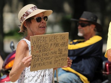 Carole Johnson from Sarnia holds up a sign during a protest against Sarnia's mandatory mask bylaw on Thursday July 30, 2020 in Sarnia, Ont. Terry Bridge/Sarnia Observer/Postmedia Network