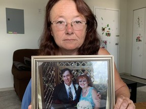 Mary Louise Foster with a framed photograph of her and her husband, Lyle, on their wedding day in July 2007. Elena De Luigi/The Daily Press