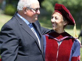 Mario Turco, former director of education of Algoma District School Board, embraces Algoma University president Asima Vezina following her investiture ceremony in June 2018. BRIAN KELLY