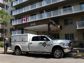 An official with the Ontario Fire Marshal's office is shown Tuesday morning outside an apartment building on Trillium Park in Sarnia.