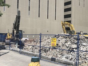 Two excavators dig through the rubble Thursday of what was once the older portion of the Salvation Army complex on Larch Street. HAROLD. CARMICHAEL/SUDBURY STAR