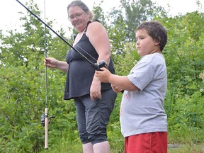 Christine Larochelle of Sudbury fishes with her grandson, Aiden, in the Vermillion River near Centennial Park on Sunday. Jim Moodie/Sudbury Star