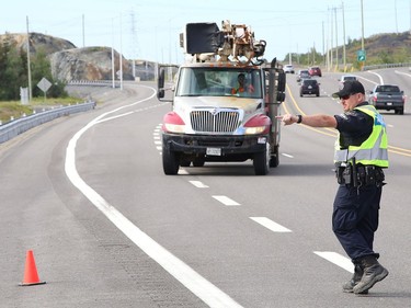 Const. Andrew Hinds, of the Greater Sudbury Police, participates in a commercial motor vehicle blitz on MR 80 in Greater Sudbury, Ont. on Friday July 17, 2020. Greater Sudbury Police and the Ontario Ministry of Transportation participated in the collaboration where officers pulled over large and small commercial vehicles addressing aggressive driving, speeding, unsafe loads and documentation. John Lappa/Sudbury Star/Postmedia Network
