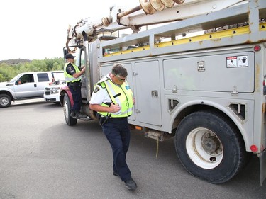 Dean Belisle, front, district enforcement manager for the MTO, and Const. Andrew Hinds, of the Greater Sudbury Police, participate in a commercial motor vehicle blitz on MR 80 in Greater Sudbury, Ont. on Friday July 17, 2020. Greater Sudbury Police and the Ontario Ministry of Transportation participated in the collaboration where officers pulled over large and small commercial vehicles addressing aggressive driving, speeding, unsafe loads and documentation. John Lappa/Sudbury Star/Postmedia Network