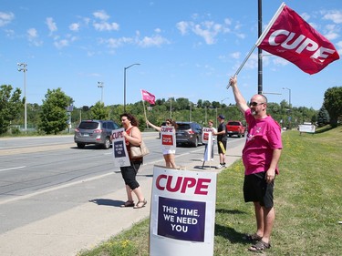 Members of CUPE Local 1623, representing various local hospital workers, take part in a rally on Paris Street near the entrance to Health Sciences North in Sudbury, Ont. on Friday July 17, 2020. The protest was part of province-wide rallies held to put pressure on the Ontario government to "restore basic workplace rights suspended for months by emergency orders during the COVID-19 pandemic. Bill 195 continues that suspension of these rights for up to 3 years," said a release from CUPE. John Lappa/Sudbury Star/Postmedia Network