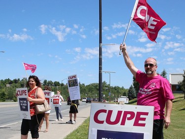 Members of CUPE Local 1623, representing various local hospital workers, take part in a rally on Paris Street near the entrance to Health Sciences North in Sudbury, Ont. on Friday July 17, 2020. The protest was part of province-wide rallies held to put pressure on the Ontario government to "restore basic workplace rights suspended for months by emergency orders during the COVID-19 pandemic. Bill 195 continues that suspension of these rights for up to 3 years," said a release from CUPE. John Lappa/Sudbury Star/Postmedia Network