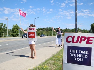 Members of CUPE Local 1623, representing various local hospital workers, take part in a rally on Paris Street near the entrance to Health Sciences North in Sudbury, Ont. on Friday July 17, 2020. The protest was part of province-wide rallies held to put pressure on the Ontario government to "restore basic workplace rights suspended for months by emergency orders during the COVID-19 pandemic. Bill 195 continues that suspension of these rights for up to 3 years," said a release from CUPE. John Lappa/Sudbury Star/Postmedia Network