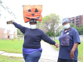 Temitope Osuntokun, left, carries her groceries on her head while walking with Silifatu Oyesiji on Wednesday.