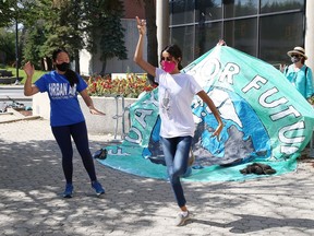 Fridays For Future climate activists Maggie Fu, left, and Sophia Mathur take part in a shoe strike with Bollywood dancing on Friday, July 24, at the corner of Brady and Paris streets. A similar event will be held this Friday at Tom Davies Square.