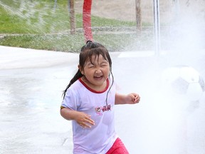 Elsa Sun, 3, cools off at the new splash pad at the Twin Forks Playground on Gary Avenue in Sudbury, Ont. on Friday July 24, 2020.