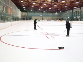 Maintenance staff at Gerry McCrory Countryside Sports Complex paint lines on the ice surface of pad two at the arena in Sudbury, Ont. on Monday July 27, 2020. The City of Greater Sudbury said in a release that the ice pad at Countryside arena will reopen on Monday, August 3, 2020, while the second pad will potentially open later in August, based on demand.