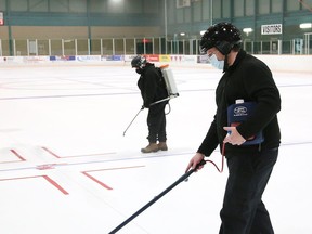 Maintenance staff at the Gerry McCrory Countryside Sports Complex paints lines on the ice surface of pad two at the arena on July 27. The City of Greater Sudbury has deferred opening the sports complex in light of recent COVID-19 diagnoses.