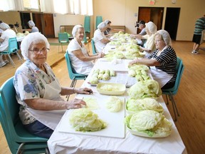 A crew prepares cabbage for cabbage rolls at St. Mary's Ukrainian Catholic Church in Sudbury, Ont. on Tuesday July 28, 2020. Cabbage rolls, pyrohy, borsch, as well as gift certificates can be purchased every Saturday from 10 a.m. to noon at the church at 40 Notre Dame Ave.