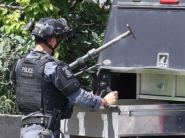 Greater Sudbury Police surrounded an apartment building on Beatty Street in Sudbury, Ont. on Thursday July 30, 2020. According to a tweet by police, just before 4:30 p.m. Thursday, tactical and K9 police officers entered a unit in the apartment building and took a 38-year-old man into custody. He is charged with numerous offences including robbery with a firearm, aggravated assault, break and enter and uttering death threats. He will attend bail court Friday. John Lappa/Sudbury Star/Postmedia Network