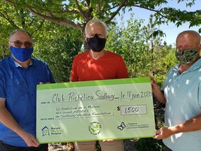 Michel Démoré (Club Richelieu Sudbury), middle, presents a cheque for the Sudbury Hospice Foundation to Gaston Lavigne (left) and Lyle Foreshaw. Supplied