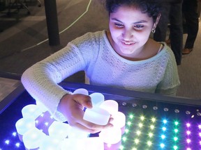 Salma Mohamed, 11, of R.L. Beattie Public School, checks out one of the interactive exhibits at the revamped fourth floor at Science North in Sudbury, Ont. on Thursday February 14, 2019. The centre will reopen to the public, on a limited basis, on Saturday. John Lappa/Sudbury Star/Postmedia Network