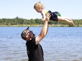 One-year-old Adaline Mckay soars over Gillies Lake on Friday with a little help from her daddy, Julian. The Mckay family, including Julian's wife Sarah and their other daughter Olivia, 3, were taking advantage of the clear sunny day before the weekend. The Environment Canada forecast for Timmins is calling for rain both Saturday and Sunday.

RICHA BHOSALE/The Daily Press