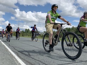 A stream of Cochrane District EMS paramedics cycled through Timmins Friday afternoon in honour of their fellow colleagues who have died in the line of duty as well as by suicide. Seen above is the procession riding down Airport Road towards Ross Avenue

 Elena De Luigi/The Daily Press