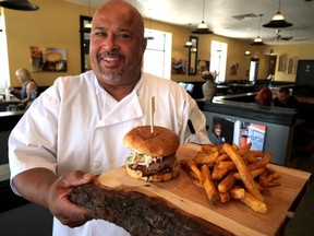 Flippin' Mike Jourdy presents the Big Smoke - smoked beef brisket atop a burger patty covered in melted spicy Havarti with homemade BBQ sauce and apple slaw on a garlic toasted bun, with a side of fresh-cut fries. It's one of 16 specialty burgers at Flippin' Mike's Tillsonburg Burger Restaurant, which officially opened July 25 at 118 Broadway. (Chris Abbott/Norfolk and Tillsonburg News)
