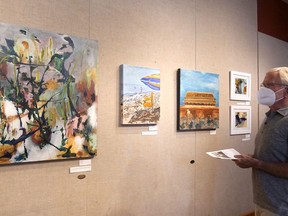 Bruce Hartley views the Ingersoll Artists in Residence exhibit at the Station Arts Centre in Tillsonburg. (Chris Abbott/Norfolk and Tillsonburg News)