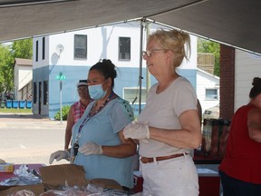 Staff and volunteers from a number of organizations braved the heatwave to host a free barbecue for residents on Canada Day..TP.JPG