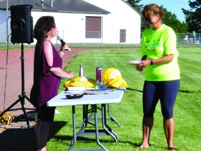 Lorraine Kirk, right, of the VPE All Stars accepts a prize on behalf of her team after Gail Wark of the Vulcan County Health and Wellness Foundation announced the VPE All Stars had finished second in the moderate category of the foundation's Fitness Challenge.