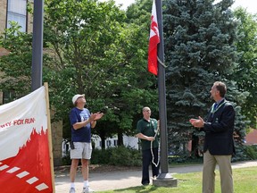 John Versaevel, the chair of the Woodstock Terry Fox Run, and Woodstock Mayor Trevor Birtch watch the raising of the Terry Fox flag at Museum Square Wednesday July 15, 2020. The day celebrates the 40th anniversary since Terry Fox and the Marathon of Hope travelled through Woodstock.

Greg Colgan/Sentinel-Review/Postmedia Network