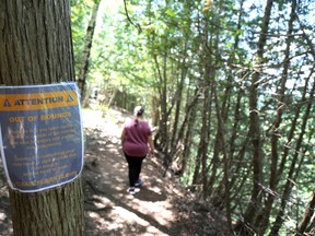 A woman walks a short distance down an out of bounds trail at Eugenia Falls Thursday afternoon. She said it wasn't that bad, but could see how someone might get hurt. Greg Cowan/The Sun Times