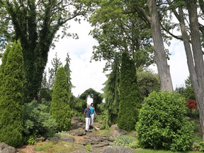 Douglas Morrison and Jane Fritz have been working on their garden overlooking Georgian Bay for 30 years. The sprawling gardens at their home just north of Owen Sound feature spring-fed ponds, bridges, fountains, a rockfall, and a pergola complete with a stained-glass window from the Kemble-Sarawak United Church. The home is one of nine stops on the Island View Drive Ratepayers Association garden tour in support of the Chapman House Residential Hospice of Grey Bruce on Aug. 8. Greg Cowan/The Sun Times.