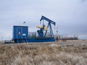 A blue-and-white pumpjack is stationary south of Fairview, Alta. on Saturday, April 25, 2020.