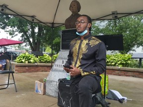 Thador Tekhli leads the gathering in taking a knee at the beginning of Saturday's Emancipation Day rally at BME Freedom Park in Chatham. (Trevor Terfloth/The Daily News)