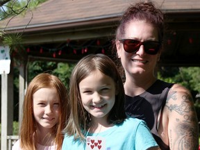 Keri Cooper poses with her daughters Lena, 10, left, and Olivia, 8, in Watford's Sunken Gardens. The Watford woman is behind a town-wide scavenger hunt currently underway. (Tyler Kula/The Observer)