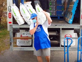 Community Develeopment Council of Quinte volunteer unloads potatoes for distribution in Good Food Market bags in Belleville.