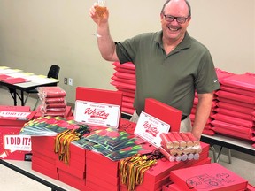 Ken McEwan, director of the Ridgetown Campus of the University of Guelph, shares a toast to the Class of 2020 while surrounded by special ‘Congrat’s in a Box’ packages ready to be mailed to graduates. Handout