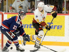 Forward Riley Robitaille, shown here throwing the puck past Crunch defender Nick Belisle towards the front of the Cochrane net during an NOJHL game at the McIntyre Arena on Feb. 4, will be back in a Timmins Rock uniform for the 2020-21 campaign. The Timmins native has played 141 games in the NOJHL, all but the first seven with the Rock. THOMAS PERRY/THE DAILY PRESS/POSTMEDIA NETWORK