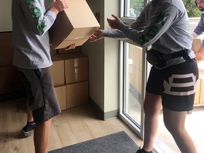 The Every Breakfast Counts program is relying on students this summer to help deliver boxes to those in need. Each box contains about 15 healthy breakfasts. Ben and Julia Howe prepare the boxes for distribution.   PHOTO SUPPLIED.