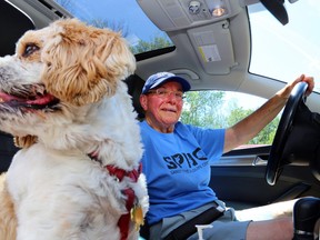 Norma Broadbear, a volunteer from Belleville, sits in her car with her constant companion, Kerry, Thursday at Sandy Pines Wildlife Centre. Broadbear has logged 18 years driving injured animals, releasing healthy ones, and helping in other ways.