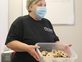 Volunteer Brenda Chartrand shows a container of blueberry scones to a customer during Friday's bake sale at H.O.P.E's Kitchen. Money raised goes to keep the diner's fridge and cupboards full to help provide the homeless a free meal.
Jennifer Hamilton-McCharles, The Nugget