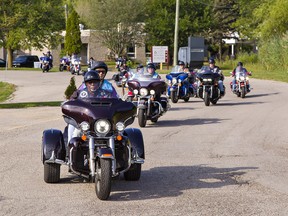 Motorcyclists taking part in a charity fundraising ride on Saturday ride past Participation Support Services in Brantford to honk and wave to the centre's residents before heading out on their route.
